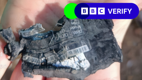 Close up image of fragments of an exploded pager in Lebanon on 18 September, with the BBC Verify branding in the top right corner of the image