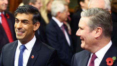 Rishi Sunak and Sir Keir Starmer walk through the Central Lobby at the Palace of Westminster ahead of the State Opening of Parliament