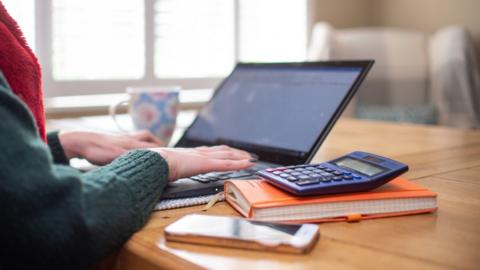 A woman working from home at her laptop