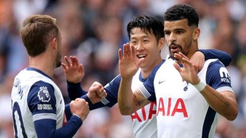 Dominic Solanke celebrates scoring his first goal for Tottenham against Brentford with team-mates Son Heung-min and James Maddison