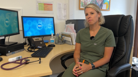 Dr Abbie Brooks sits in GP surgery