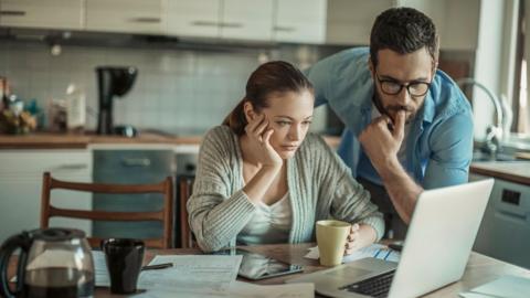 Stock image of couple looking at laptop