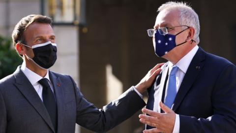 French President Emmanuel Macron claps the shoulder of Australia Prime Minister Scott Morrison at a meeting in Paris in June 2021