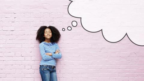 Young girl standing against a pale pink brick wall - she looks thoughtful and has her eyes close. An illustrated thought bubble is attached to her head.