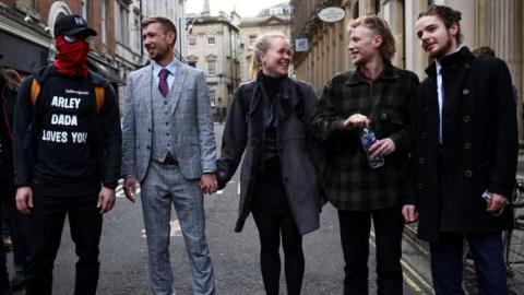From l-r Jake Skuse (in a mask), a friend in a grey checked suit, Rhian Graham, Milo Ponsford, and Sage Willoughby arrived at court together