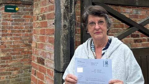 Catherine Bearder outside home with European Flag