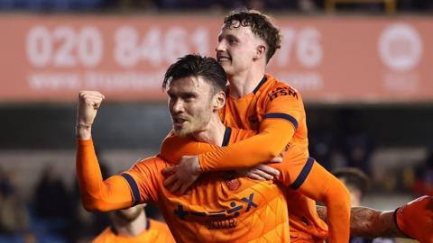 Ipswich players celebrate Kieffer Moore's goal at Millwall