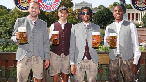 Harry Kane, Jamal Musiala, Michael Olise and Mathys Tel hold up beers at Oktoberfest