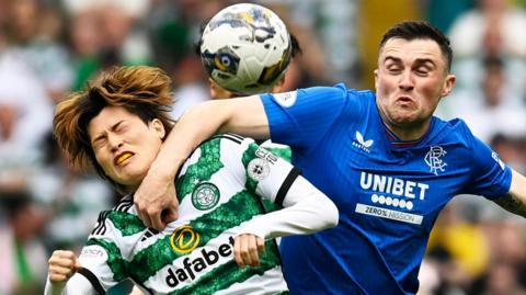 Celtic and Rangers players battle for the ball