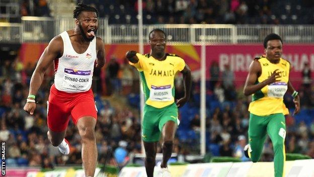 England's Emmanuel Oyinbo-Coker (left) wins the men's 100m T45-47 final at the Commonwealth Games