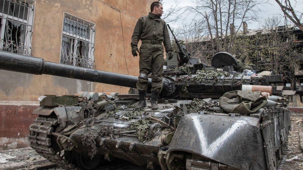 russian soldier on tank near plant