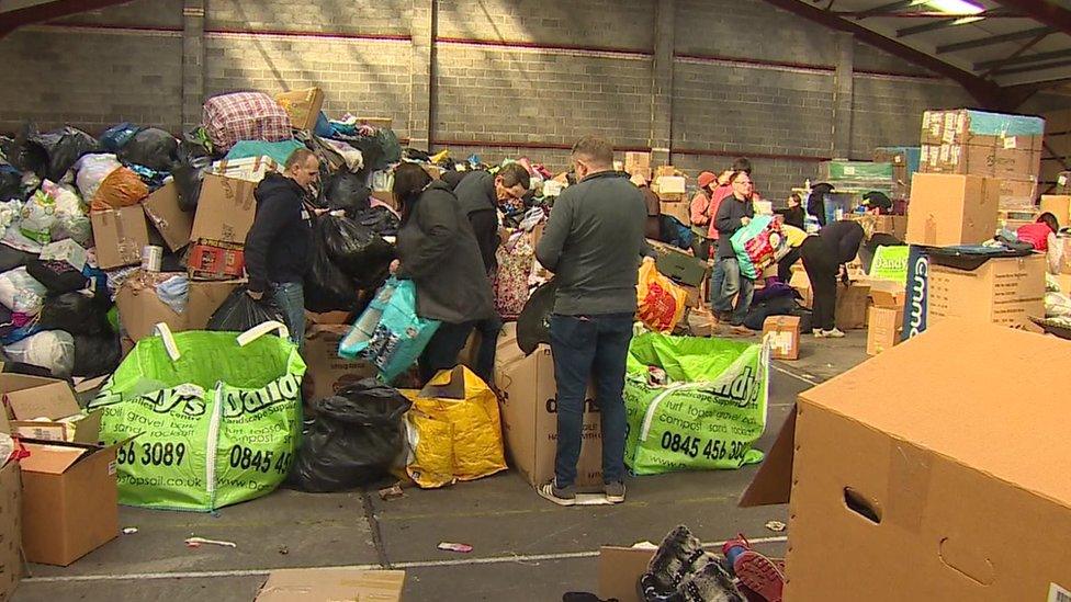 Warehouse full of donation and volunteers