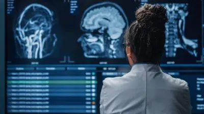 A scientist looking at MRI tests