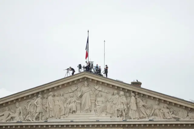 Security forces deploy at the top of the French Parliament during the Opening Ceremony of the Paris 2024 Olympic Games