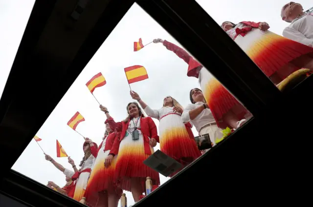 Athletes from Team Spain wave Spanish flags during the opening ceremony