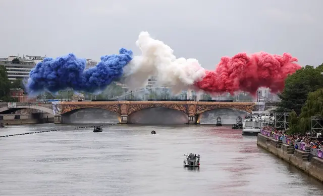 Smoke resembling the flag of Team France is shown over Pont d’Austerlitz during the opening ceremony of the Olympic Games Paris 2024 on July 26, 2024 in Paris, France