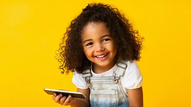 Young black girl holidng a mobile phone