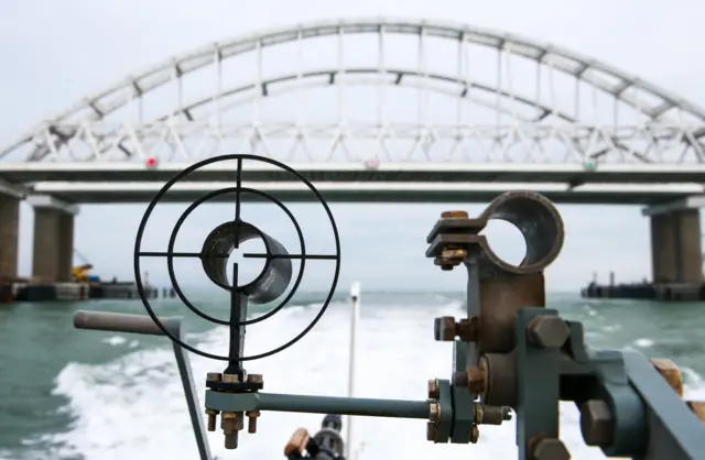 A patrol boat of the coast guard of the Border Service under the Russian Federal Security Service approaches the Kerch Strait Bridge linking the Crimean Peninsula and mainland Russia