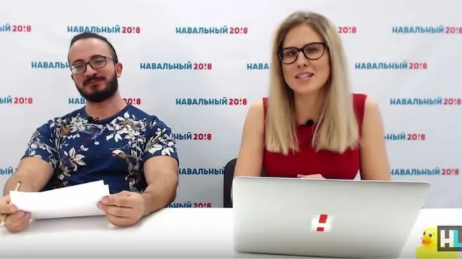 Lyubov Sobol (right) presents the news via her YouTube channel