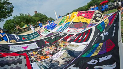 Volunteers place panels of the Aids Memorial Quilt on the National Mall in Washington DC