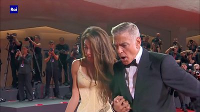 Amal and George Clooney seeing a photographer falling