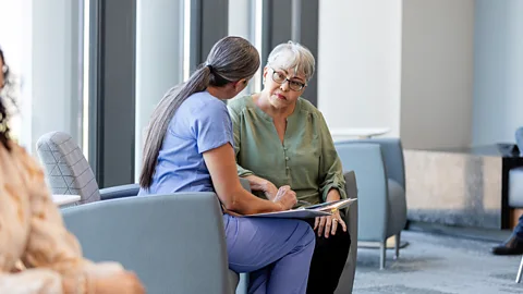 Getty Images Nurse consoles patient