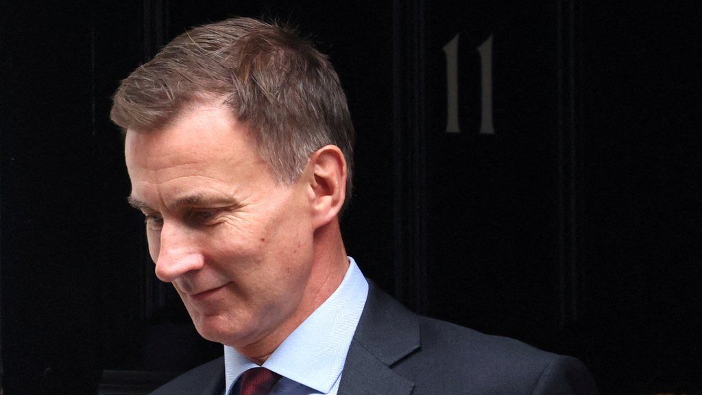 British Chancellor of the Exchequer Jeremy Hunt leaves Downing Street in London.