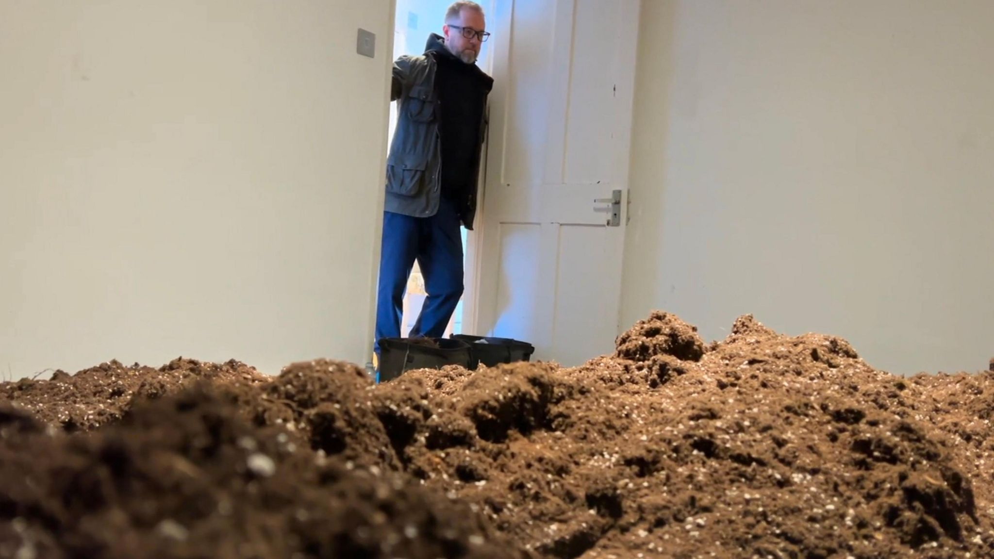 Mr Reeves surveys his once-comfortable bedroom