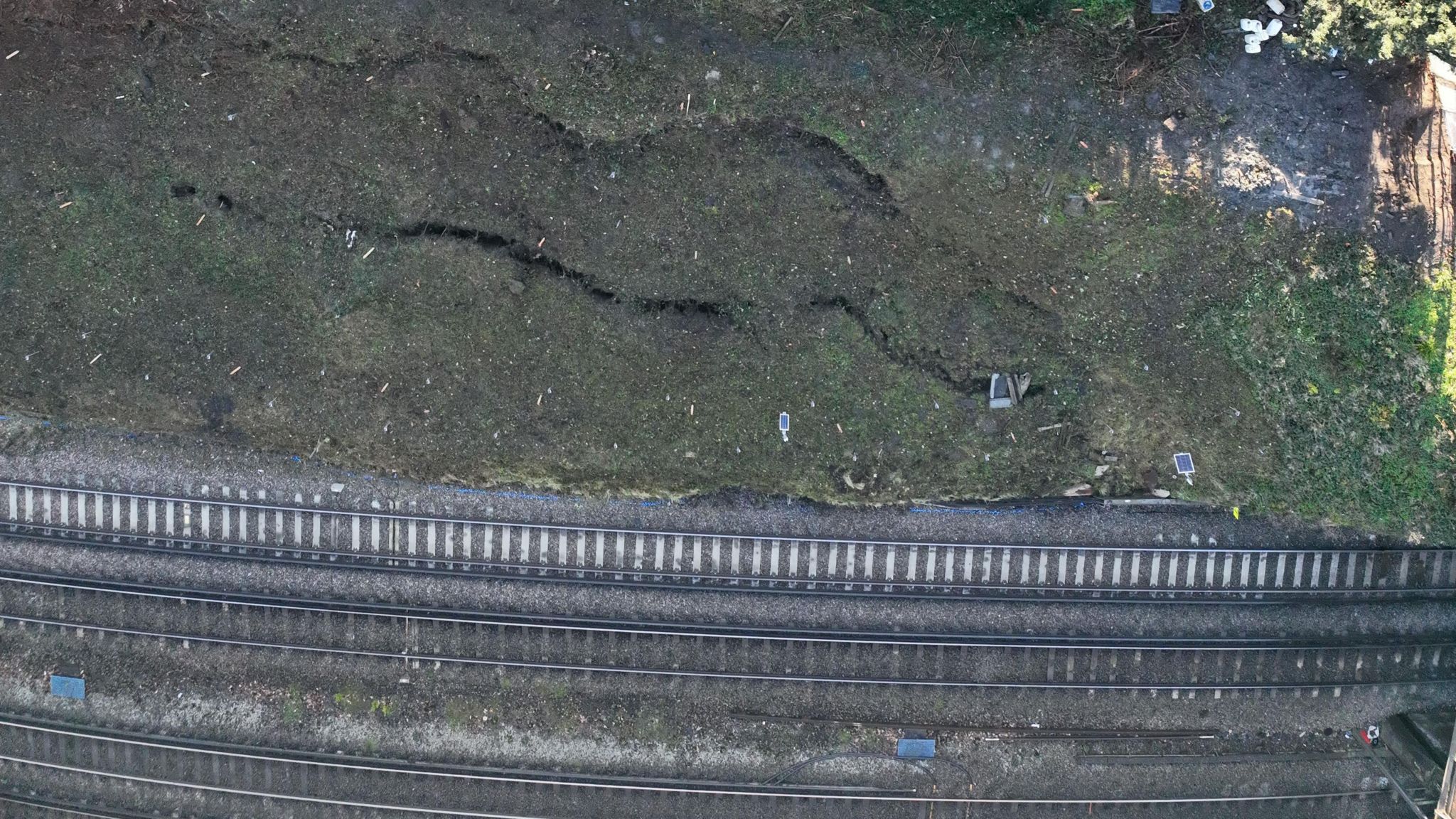 Cracks in the ground next to the train track