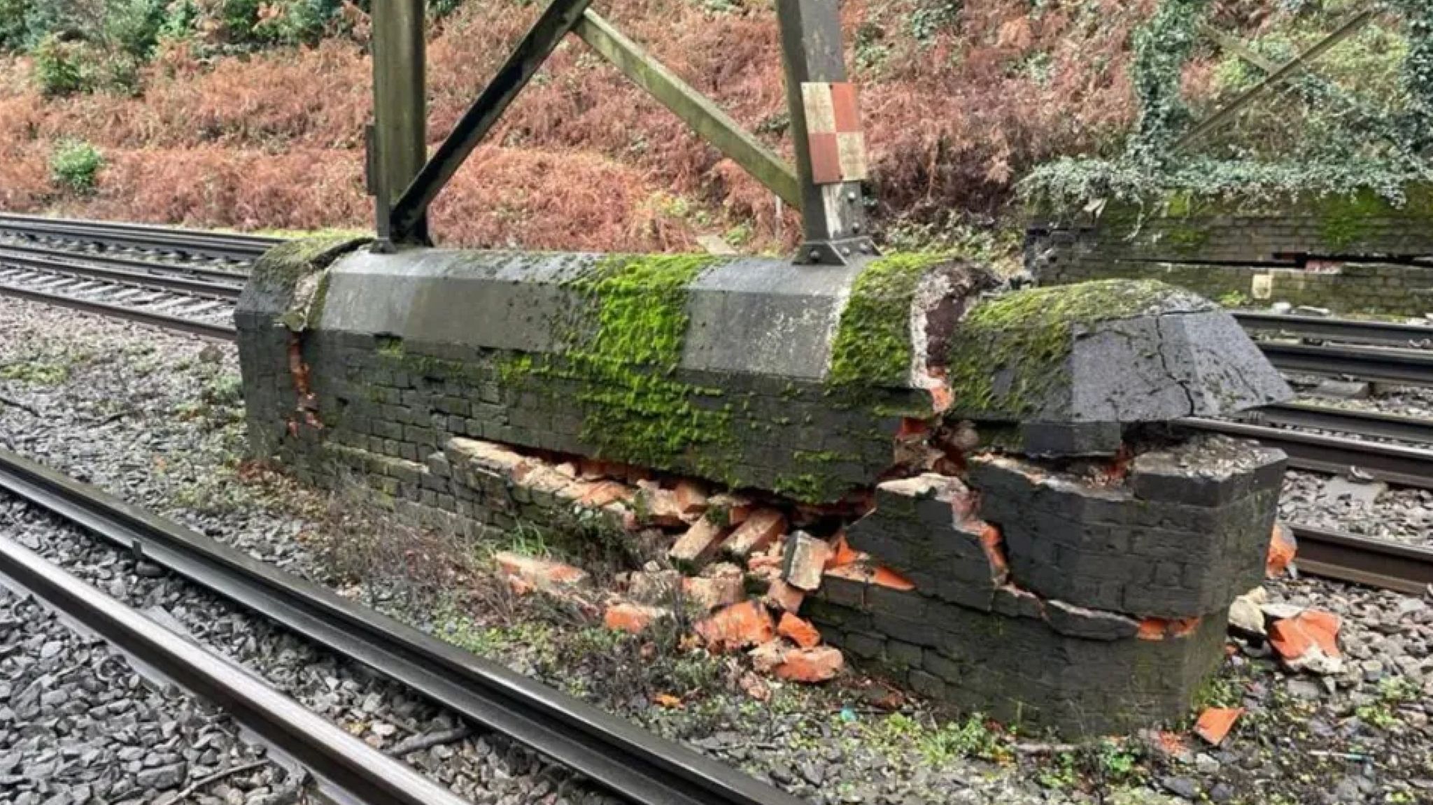 Cracked base of a bridge over a railway track 