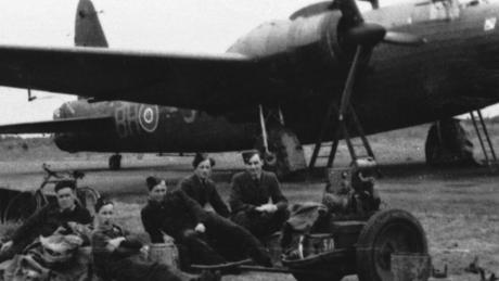 WW2 Polish airmen and ground crews sitting in front of a plane at RAF Ingham