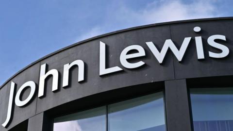 The words 'John Lewis' in large white letters on a black shop front