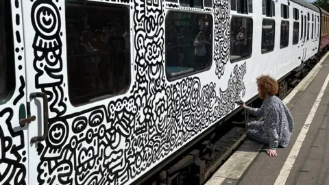 Phil Harrison/BBC Mr Doodle drawing on a train carriage