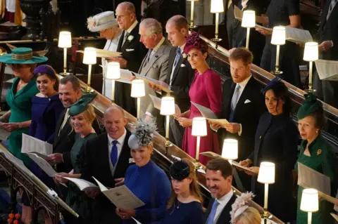 PA Queen Elizabeth II, the Duke of Edinburgh, the Prince of Wales, the Duke of Cambridge, the Duchess of Cambridge, the Duke of Sussex, the Duchess of Sussex and the Princess Royal, (left to right front row) Sarah Ferguson, Princess Beatrice, Peter Phillips, Autumn Phillips, Mike Tindall, Zara Tindall, Lady Louise Mountbatten-Windsor and Crown Prince Pavlos of Greece at the wedding of Princess Eugenie to Jack Brooksbank at St George's Chapel in Windsor Castle