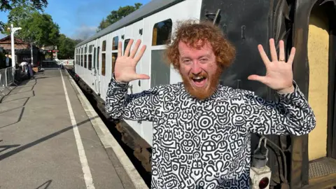 Phil Harrison/BBC Mr Doodle with a Kent & East Sussex Railway carriage 