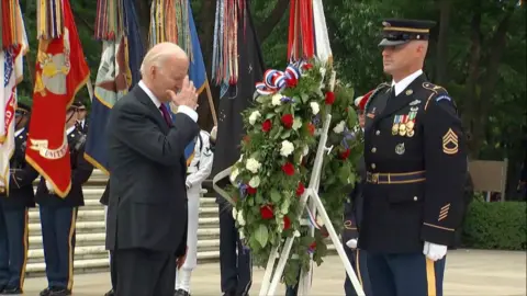 US President Joe Biden places a wreath of flowers at the Tomb of the Unknown Soldier
