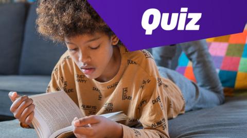 A child reading a dictionary with the text "Quiz" in the top right corner