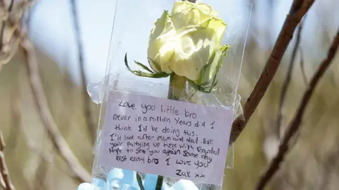 Flowers left by the brother of British teenager Jay Slater near the site in Tenerife where his body was found