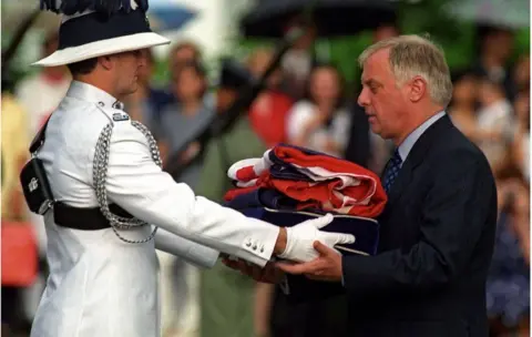 AFP Chris Patten receives the Union Jack flag