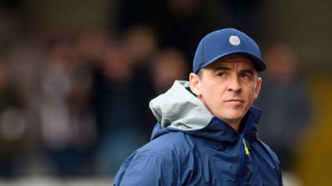 Mid shot of Joey Barton wearing a cap and jacket