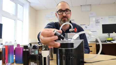 Prof Chris Pudney using scientific equipment