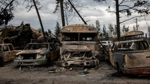A general view of burnt buses and cars in Jasper, Alta., on Friday, July 26, 2024