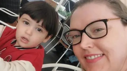 Catherine Flanagan taking a selfie beside her son David, who is wearing a red and cream jacket