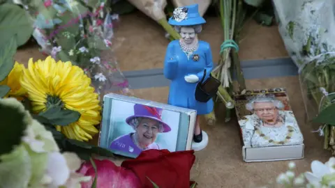 Getty Images A doll of the queen and matchboxes carrying her picture
