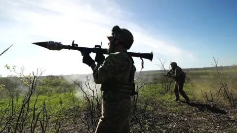 BBC/Lee Durant A member of the Ukrainian military prepares to fire a rocket-propelled grenade (RPG) near the city of Bakhmut