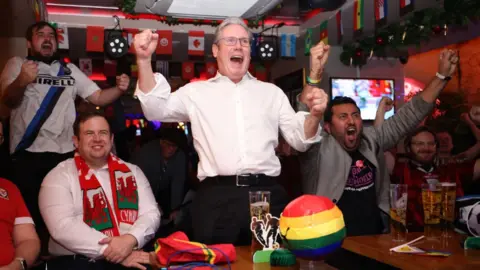 Getty Images Sir Keir celebrates an England goal during a 2022 Fifa Wold Cup match against Wales