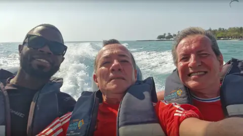 Yostin Mosquera, 34, Paul Longworth, 71 and Albert Alfonso, 62, on a boat in Colombia