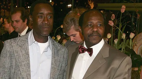 Getty Images Actor Don Cheadle (L) and Paul Rusesabagina arrive at the "Hotel Rwanda" Premiere during the 55th annual Berlinale International Film Festival on February 11, 2005 in Berlin, Germany.