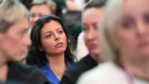 Getty Images Margarita Simonyan, editor in chief of Russia Today, sits in a crowd of Putin supporters in Moscow on January 31, 2024.