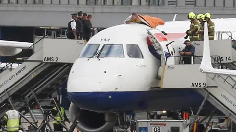 Reuters A man on top of plane at London City Airport